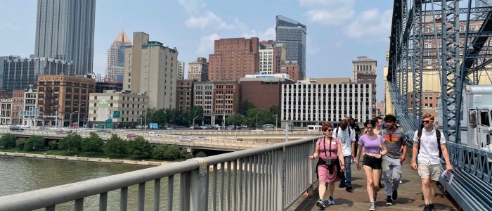 Students walking on a bridge in downtown Pittsburgh