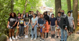 Group of students in woods in front of Fallingwater